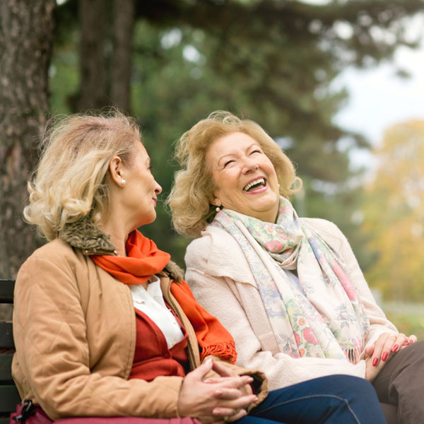 two senior women laughing