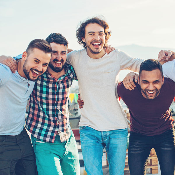 four male friends smiling together