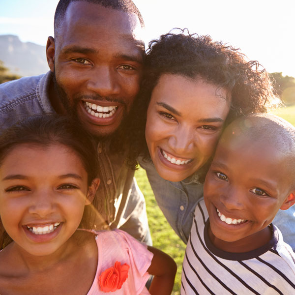 family of four smiling